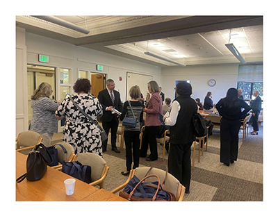 WSCAI Olympia Day attendees networking and speaking with legislators inside a Capitol conference room
